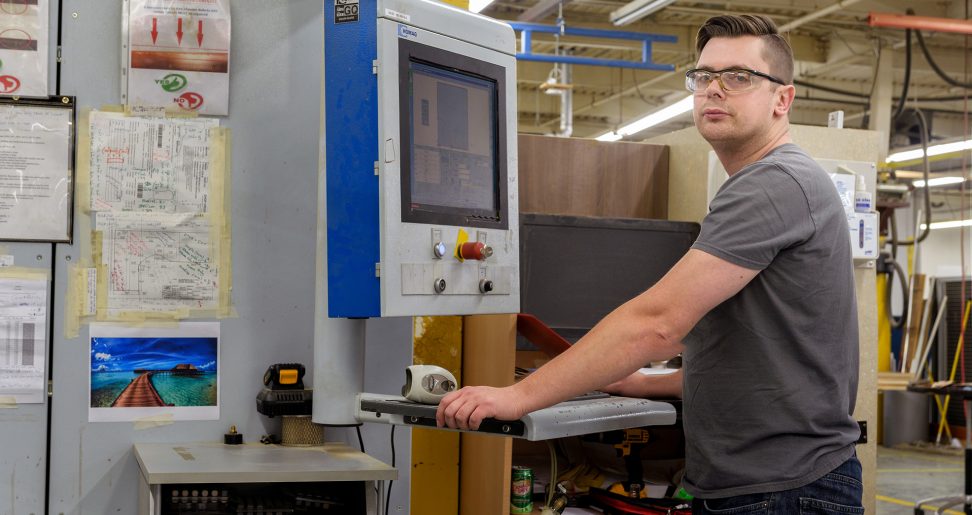 Rafal Legiezynski operating machinery in plant