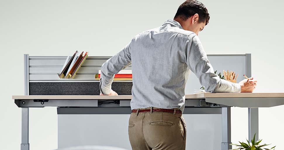 Man working on the adjustable desk 